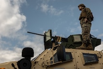 U.S. Marine Corps Noah Bowels, an engineer equipment mechanic with 3rd Maintenance Battalion, 3rd Marine Logistics Group, stands on top of a Joint Light Tactical Vehicle at Camp Hansen, Okinawa, Japan, Dec. 22, 2023. The reason for the training was to increase their lethality, survivability, and capability when it comes to employing the M2 .50 Caliber machine gun in a mounted platform. (U.S. Marine Corps photo by Lance Cpl. Weston Brown)