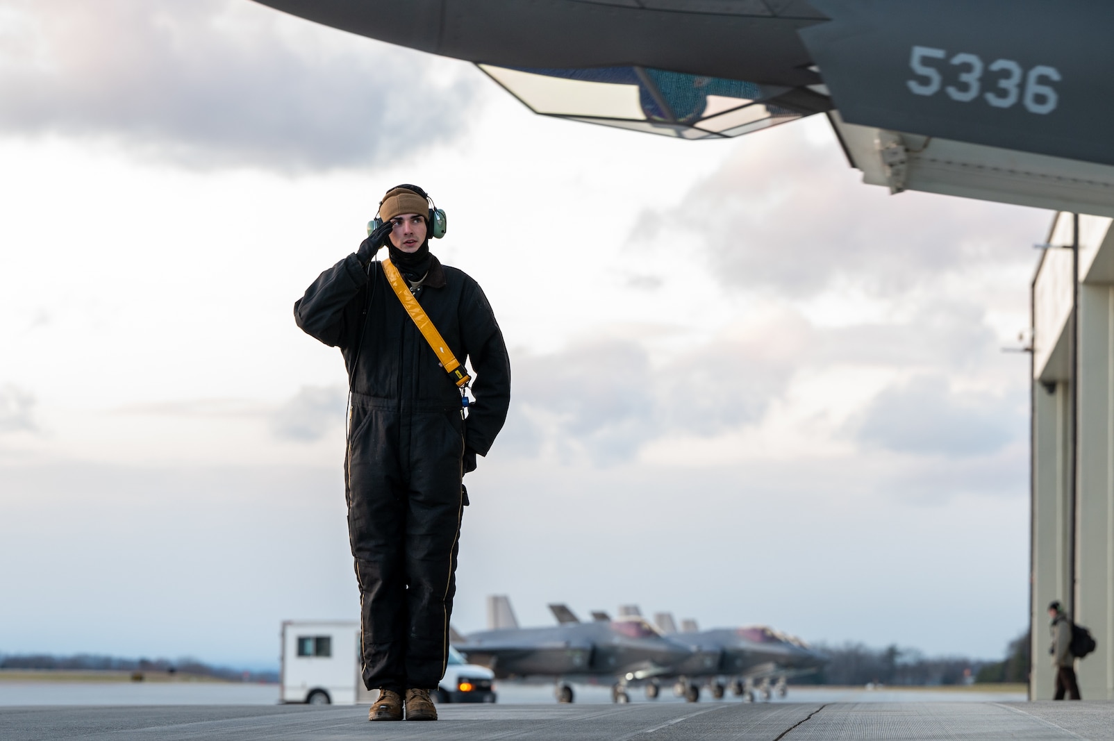 Photo of an Airman assigned to the 158th Fighter Wing, salutes an F-35A Lightning II before takeoff at the Vermont Air National Guard Base, South Burlington, Vermont, November 30, 2023.
