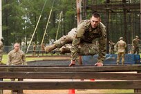 U.S. Army Reserve Sgt. 1st Class Christopher Bogard, an Army Reserve career counselor from San Antonio, Texas, with 4th Battalion, Army Reserve Career Division, attempts the six vault, the first timed obstacle of the Fort Bragg Air Assault School Obstacle Course. Touching the wood with any part of the body other than the hand results in disqualification, requiring the competitor to be returned to the beginning of the lane to try again or continue with a loss of points.  Thirty-six warriors continue to vie for the title of United States Army Reserve Best Warrior during the grueling multifaceted competition that has so far included elements of physical training, weapons marksmanship and familiarization, warrior tasks and battle drills, essay writing, German Armed Forces Proficiency Badge testing and many other events. The competition began 9 June and will conclude with an awards luncheon 15 June, 2018 (U.S. Army Reserve photo by Sgt. 1st Class Lisa M. Litchfield/released).