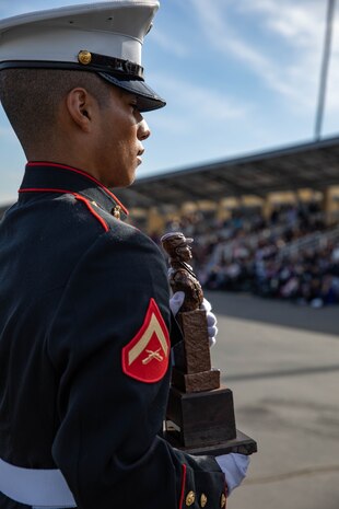 U.S. Marine Corps Lance Cpl. Joshua Velasco, a Riverside, California native with Lima Company, 3rd Recruit Training Battalion, receives the Chesty Puller Award for graduating as the Company Honor Graduate at Marine Corps Recruit Depot San Diego, Dec. 20, 2023. Graduations took place at the completion of the 13-week transformation process, which included training for drill, marksmanship, basic combat skills, and Marine Corps customs and traditions. (U.S. Marine Corps Photo by Lance Cpl. Sarah M. Grawcock)
