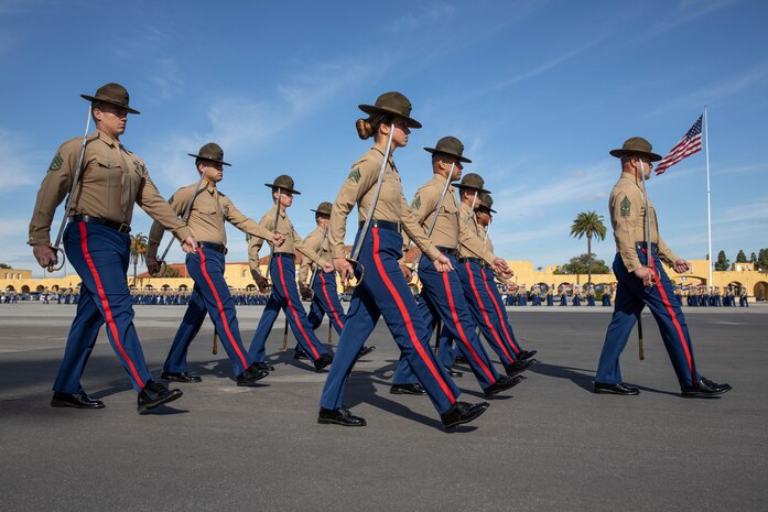 U.S. Marine Corps drill instructors with Lima Company, 3rd Recruit Training Battalion, march in formation during a graduation ceremony at Marine Corps Recruit Depot San Diego, Dec. 20, 2023. Graduation took place at the completion of the 13-week transformation process, which included training for drill, marksmanship, basic combat skills, and Marine Corps customs and traditions. (U.S. Marine Corps photo by Lance Cpl. Sarah M. Grawcock)