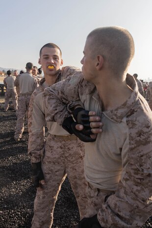 U.S. Marine Corps Recruit Samuel Bartholomew, left, a native of Merced, California and Recruit Samuel Hull, a native of Reno, Nevada, with Delta Company, 1st Recruit Training Battalion, prepare to execute a technique during a Marine Corps Martial Arts Program training event at Marine Corps Recruit Depot San Diego, Dec. 28, 2023. MCMAP aims to strengthen the mental and moral resiliency of recruits and Marines through realistic combative training, warrior ethos studies, and physical hardening. (U.S. Marine Corps photo by Lance Cpl. Janell B. Alvarez)