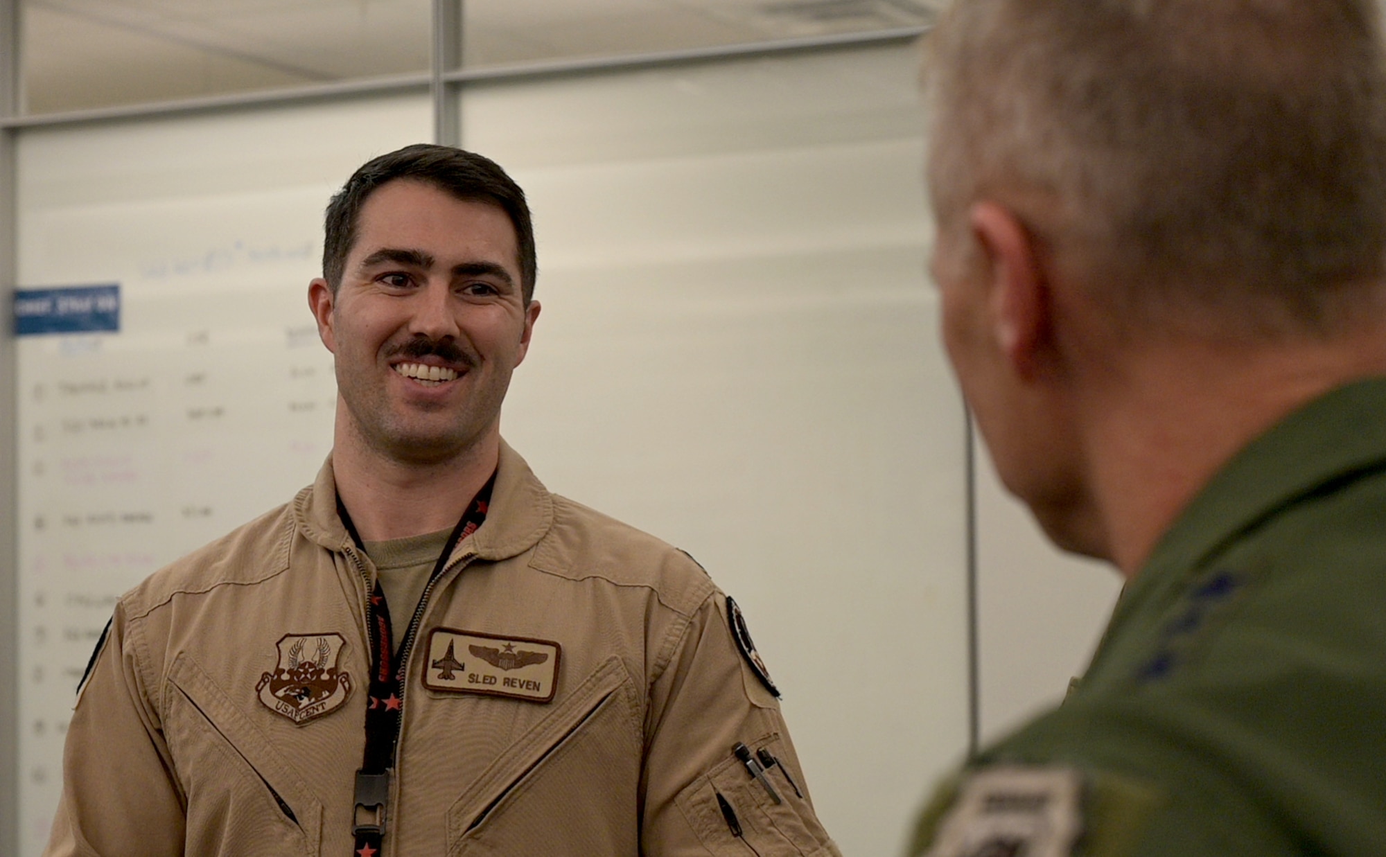 Capt. Patrick Reven, Ninth Air Force (Air Forces Central) strategic planner, explains his responsibilities in support of the mission to Gen. Mark Kelly.