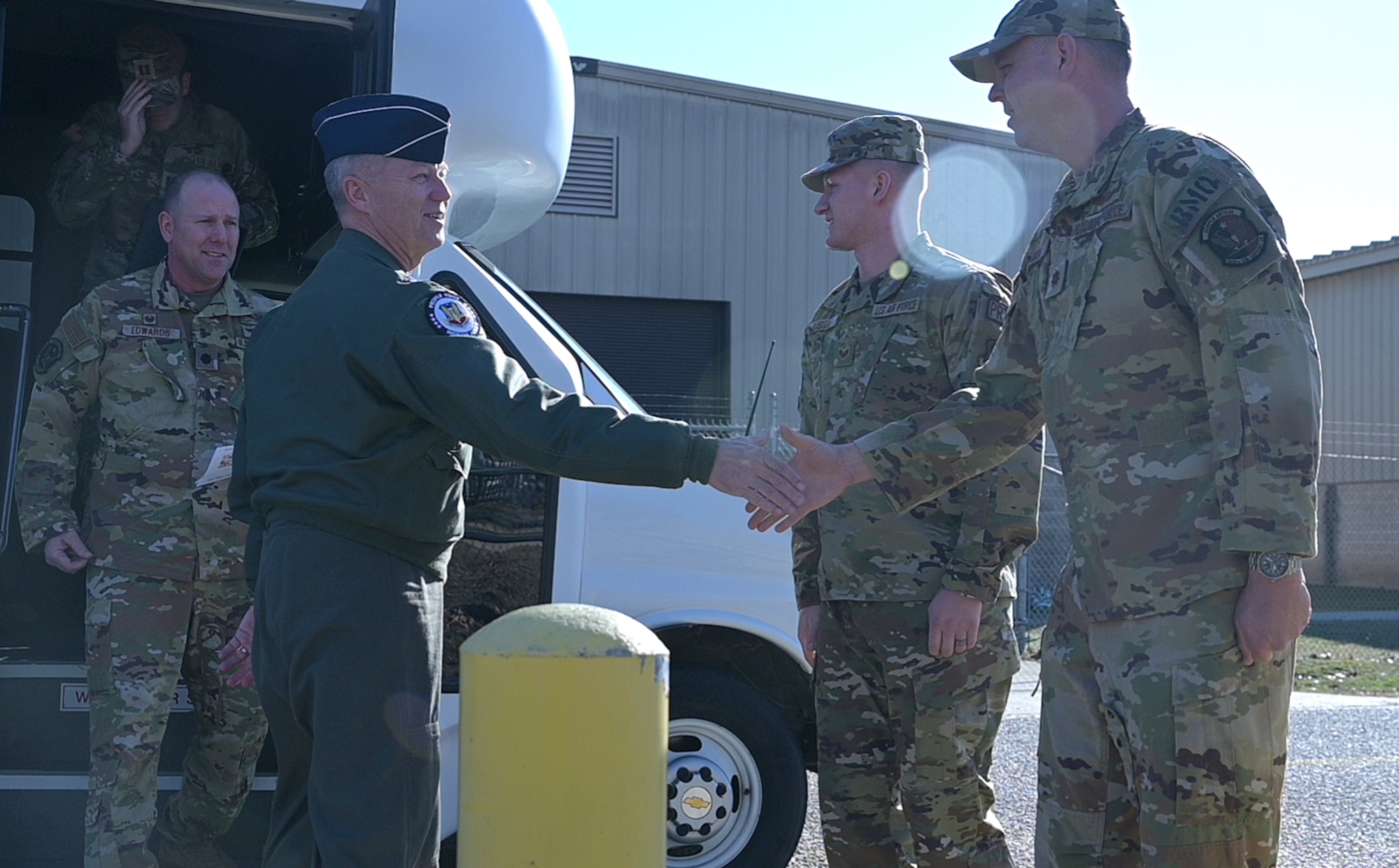 Gen. Mark Kelly, commander of Air Combat Command, shakes hands with Airmen.
