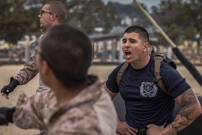 U.S. Marine Corps Drill Instructor Sgt. Andre Madruga, with India Company, 3rd Recruit Training Battalion, instructs recruits during the confidence course at Marine Corps Recruit Depot San Diego, Dec. 18, 2023. The confidence course challenges recruits physically, mentally, and spiritually through obstacles that require confidence in their strength, balance, and determination. Madruga is a native of Tracy, California. (U.S. Marine Corps photo by Lance Cpl. Jacob B. Hutchinson)