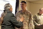 Maj. Andrew Sanchez, a branch chief under the Deputy Chief of Staff for Logistics (G4), was pinned with the major rank by his mother, Lucia Kulbartz, during a promotion ceremony at Camp Lincoln in Springfield on Jan. 6. The two shared an embrace after Sanchez received his new rank.