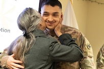 Maj. Andrew Sanchez, a branch chief under the Deputy Chief of Staff for Logistics (G4), was pinned with the major rank by his mother, Lucia Kulbartz, during a promotion ceremony at Camp Lincoln in Springfield on Jan. 6. The two shared an embrace after Sanchez received his new rank.