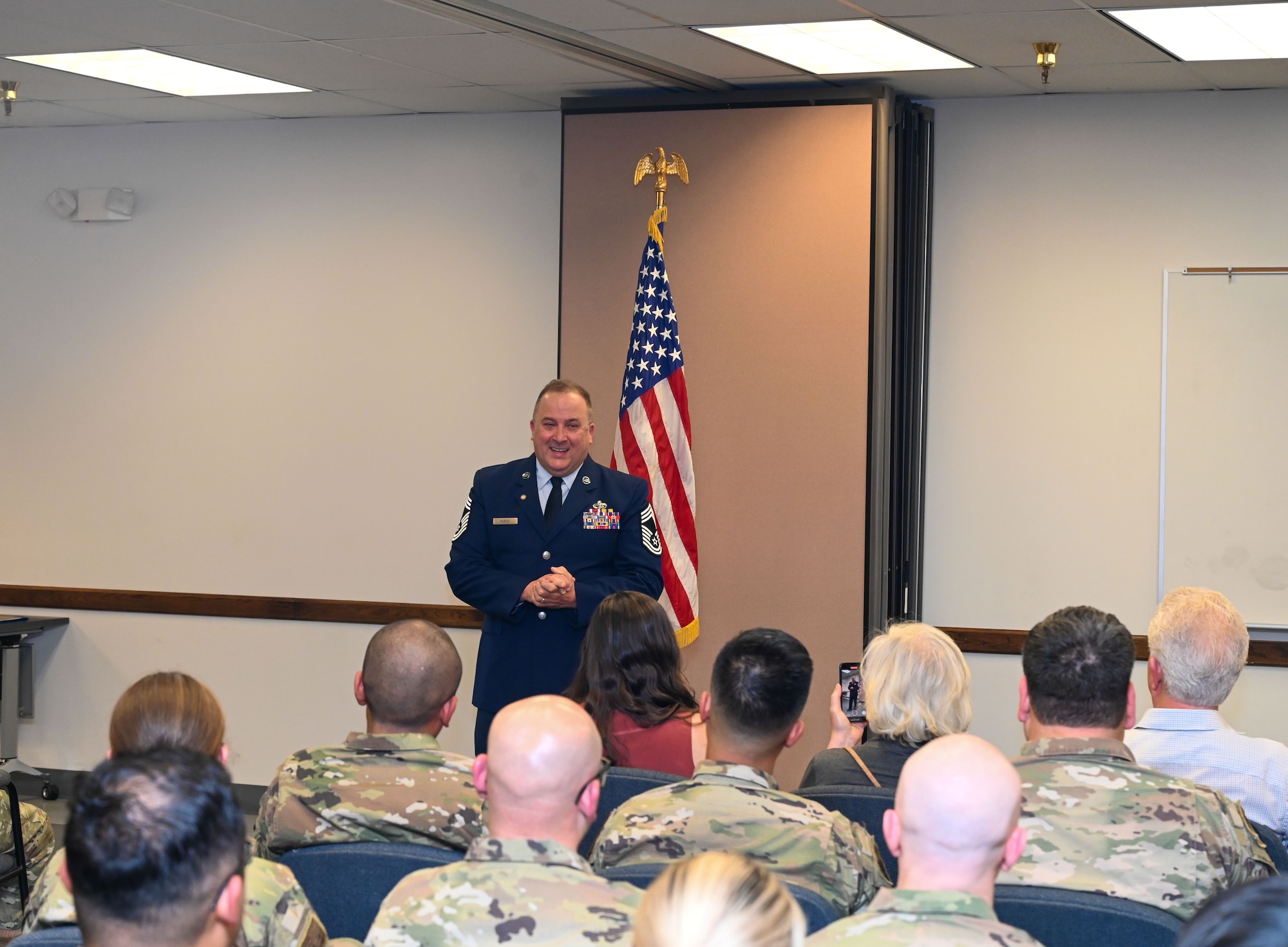 Chief Master Sgt. Steven Purvis, former 74th Aerial Port Squadron superintendent, gives closing remarks during a ceremony in San Antonio, Texas, Jan. 6, 2024. The 74th APS is responsible for the full spectrum logistics, operations, programs and exercise support for the 433rd Airlift Wing. Purvis retired with more than 30 years of military service. (U.S. Air Force photo by Staff Sgt. Adriana Barrientos)