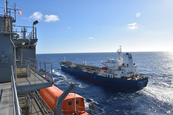 Military Sealift Command (MSC) dry cargo ship USNS Matthew Perry (T-AKE 9) approaches MSC chartered ship motor tanker Badlands Trader during a consolidated cargo replenishment operation in the vicinity of Okinawa, Japan, Dec. 15.