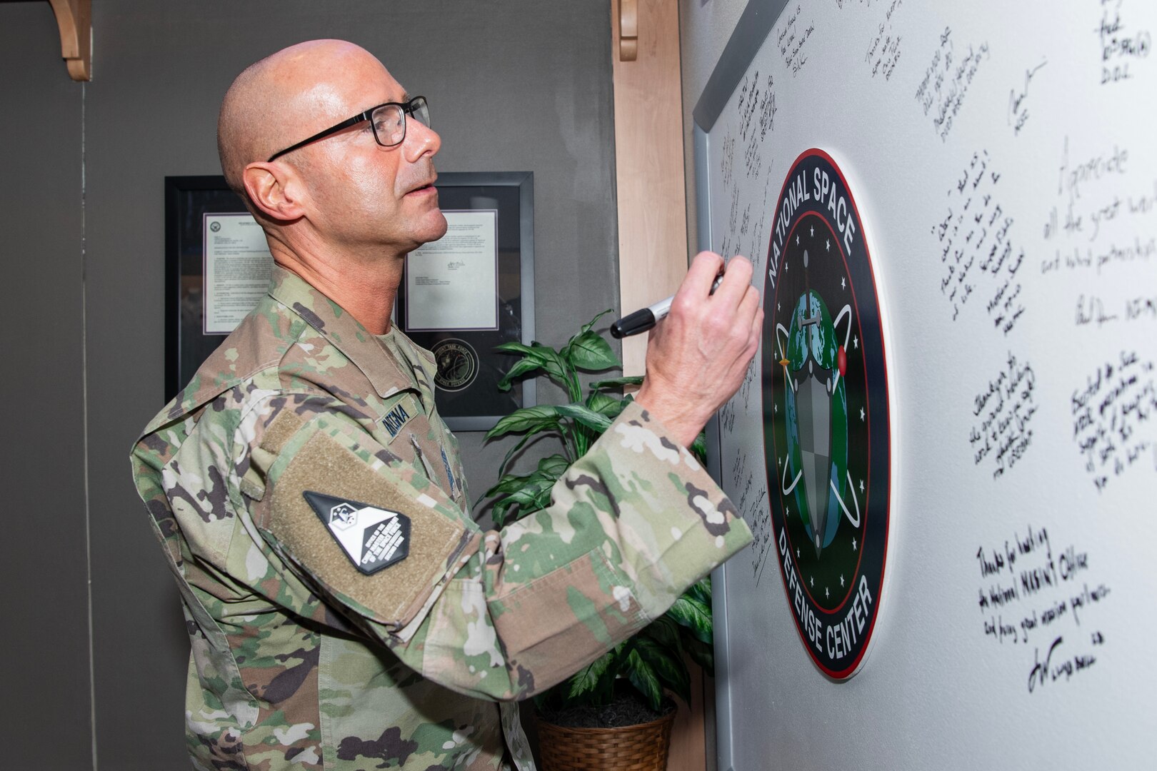 man in military uniform signing board