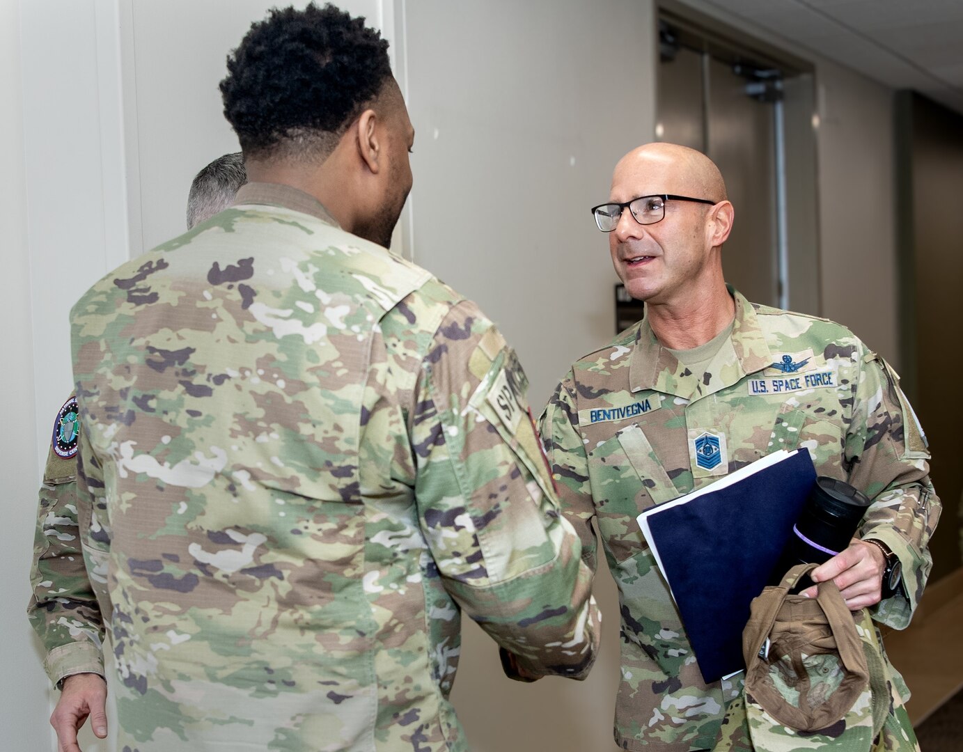 two men in military uniforms shaking hands