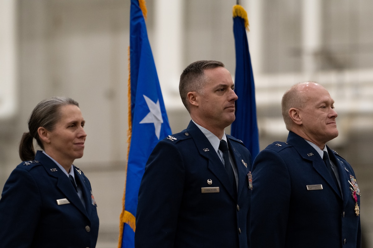 New York Air National Guard Maj. Gen. Denise Donnell, Col. Ryan Dannemann and Brig. Gen. Gary Charlton stand next to each other during a change of command ceremony.