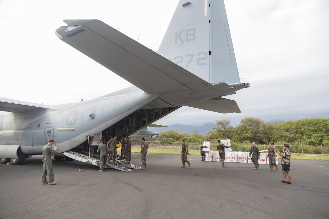 U.S. Marines with Marine Aerial Refueler Transport Squadron (VMGR) 153, Marine Aircraft Group 24, 1st Marine Aircraft Wing and 4th Reconnaissance Battalion unload toys to pass out to children in Maui, Hawaii on Dec. 21, 2023. VMGR-153 supported the Toys for Tots mission by transporting personnel and toys to assist in delivering a message of joy and hope to children throughout the holiday season. (U.S. Marine Corps photo by Lance Cpl. Clayton Baker)
