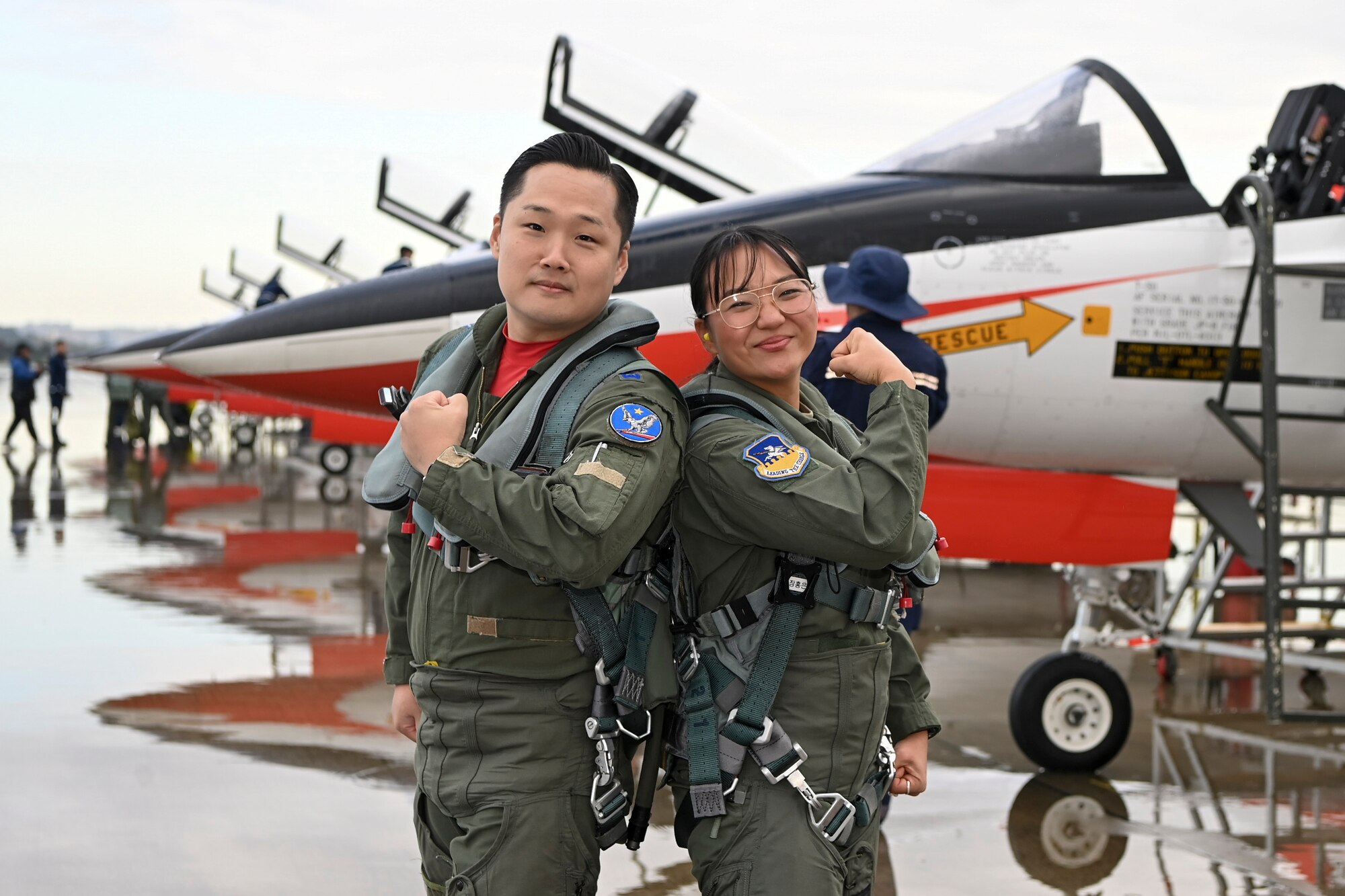 Republic of Korea Air Force Maj. Cho Wonbin, KT-50 instructor pilot, and U.S. Air Force 1st Lt. Michelle Chang, 51st Fighter Wing public affairs officer, pose for a photo in front of a KT-50 at Seoul Air Base, ROK, October 21, 2023.