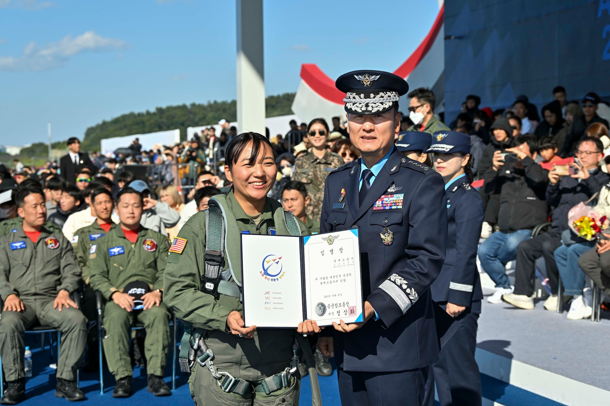 U.S. Air Force 1st Lt. Michelle Chang, 51st Fighter Wing public affairs officer, and General Jung Sang-Hwa, former Chief of Staff of the Republic of Korea Air Force, pose for a photo during an official ceremony, at Seoul Air Base, ROK, October 21, 2023.