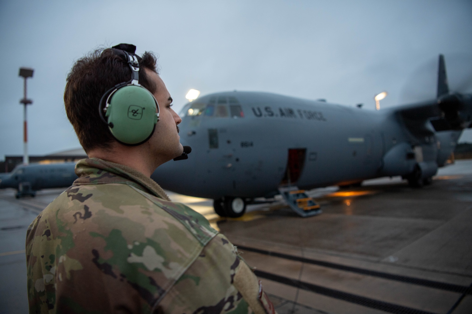 U.S. Air Force Senior Airman Maximus Jensen, 37th Airlift Squadron instructor loadmaster, prepares a C-130J Super Hercules aircraft for takeoff at Ramstein Air Base, Germany, Dec. 15, 2023.