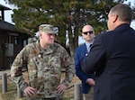 Bron Howard, 97th Civil Engineer Squadron (CES) engineering flight chief, and Matthew Hamilton, 97th CES portfolio optimization element chief, give a brief to Brig. Gen. William Kale, Air Force Civil Engineer Center commander, at Altus Air Force Base, Oklahoma, Dec. 12, 2023. The team discussed plans of improvement to the base. (U.S. Air Force photo by Senior Airman Miyah Gray)