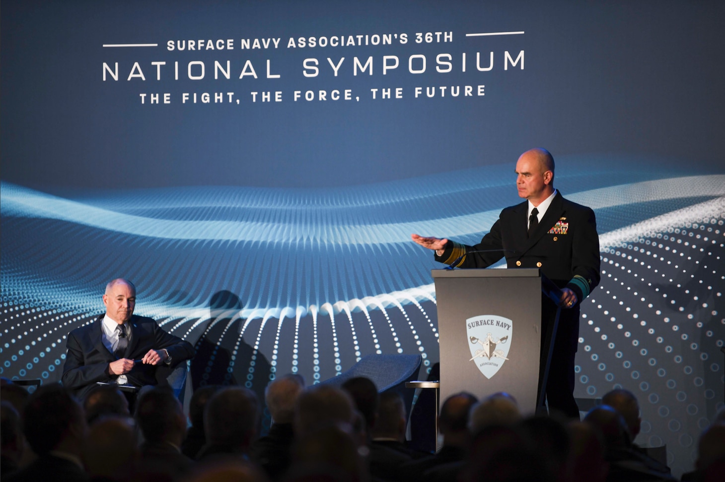 ARLINGTON Va. (Jan. 09, 2024)  Commander, Naval Surface Forces, U.S. Pacific Fleet Vice Adm. Brendan McLane delivers remarks at the Surface Navy Association’s (SNA) 36th National Symposium. The Symposium brings together joint experts and decision-makers in the military, industry, and Congress to discuss how the Surface Force is a critical element of national defense and security. (U.S. Navy photo by Mass Communication Specialist 1st Class Kelby Sanders)