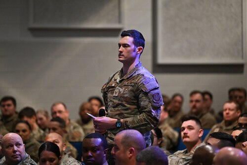 U.S. Air Force Tech. Sgt. Brett Erklenz stands in the audience of sitting airmen.