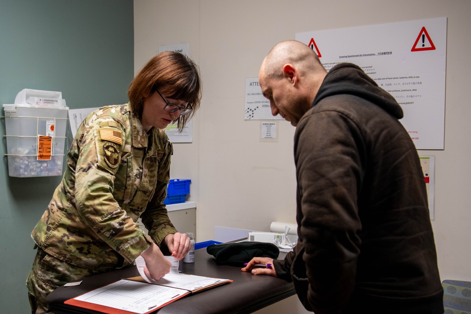 U.S. Air Force Staff Sgt. Nicholette Drew, 374th Healthcare Operation Squadron immunizations technician, cares for a patient.