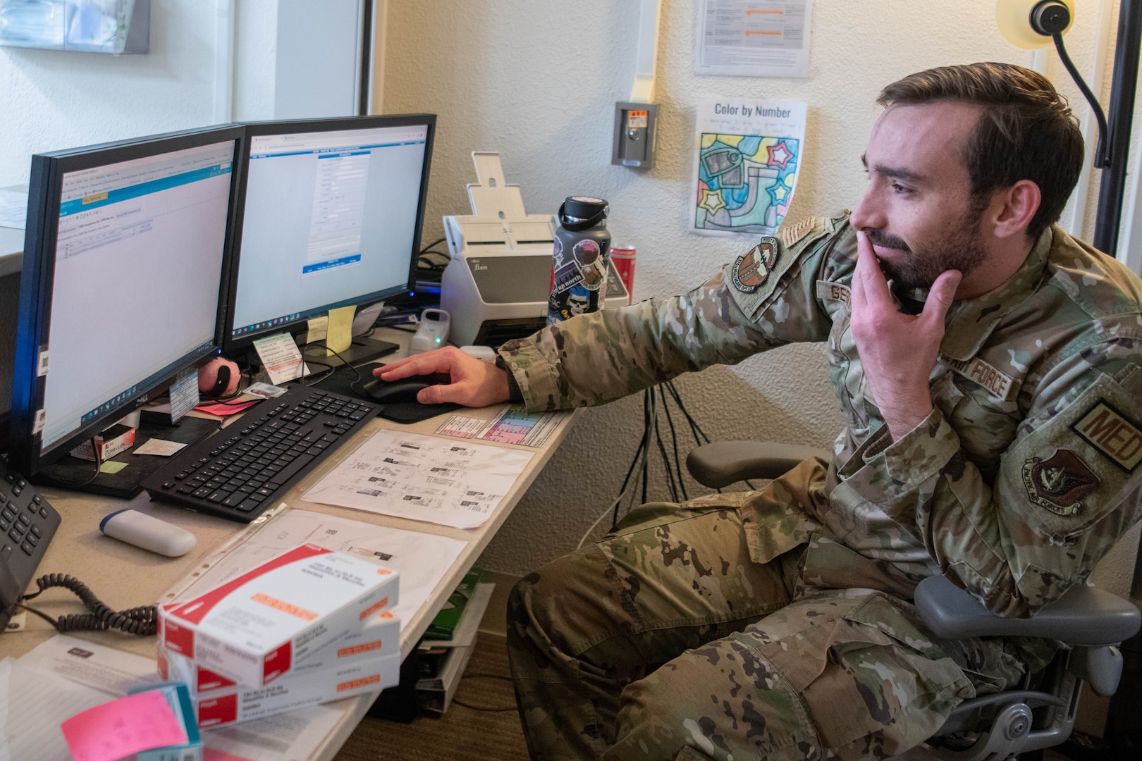 U.S. Air Force Senior Airman Andrew Geringer, 374th Healthcare Operation Squadron immunizations technician, works the front desk.