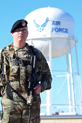 U.S. Air Force Master Sgt. Eric Emerson, 17th Security Forces Squadron standardization and evaluation superintendent, stands in front of an Air Force water tower, Goodfellow Air Force Base, Dec. 5, 2023. Emerson has been in the Air Force for 14 years. (U.S. Air Force photo by Airman 1st Class Madison Collier)