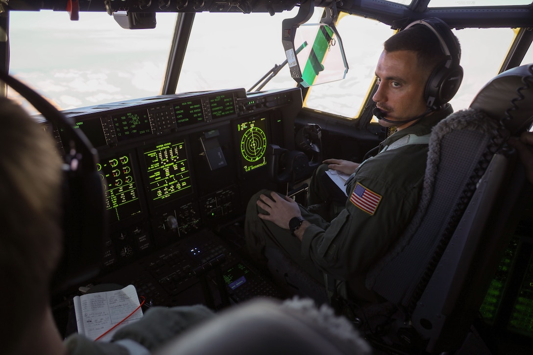 U.S. Marine Corps Maj. John Coutoumas, a pilot with Marine Aerial Refueler Transport Squadron (VMGR) 153, Marine Aircraft Group 24, 1st Marine Aircraft Wing, operates a KC-130J Hercules in Anchorage, Alaska, Dec. 13, 2023. VMGR-153 conducted combat assault transport and air delivery in support of Alaska Marines’ Toys for Tots mission which enhanced combat readiness and supported community relations in remote Alaskan villages. (U.S. Marine Corps photo by Staff Sgt. Olivia Ortiz)
