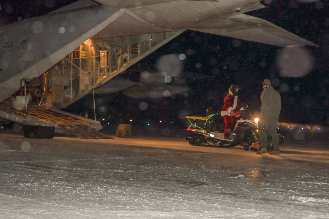 U.S. Marines with 4th Law Enforcement Battalion, Marine Forces Reserve, unload snow machines from a KC-130J Hercules assigned to Marine Aerial Refueler Transport Squadron (VMGR) 153, Marine Aircraft Group 24, 1st Marine Aircraft Wing to carry out the Toys for Tots mission in Galena, Alaska, Dec. 13, 2023. VMGR-153 conducted combat assault transport and air delivery in support of Alaska Marines’ Toys for Tots mission which enhanced combat readiness and supported community relations in remote Alaskan villages. (U.S. Marine Corps photo by Staff Sgt. Olivia Ortiz)