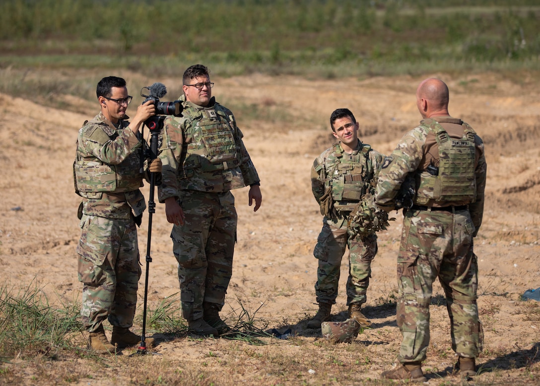 Staff Sgt. Oscar Gollaz and Capt. H. J. Howey of the Wisconsin Army National Guard’s 112th Mobile Public Affairs Detachment interview a weapons squad leader from the 1st Battalion, 506th Infantry Regiment Sept. 17, 2023 during anti-tank weapon systems training at Camp Adazi, Latvia. 112th Mobile Public Affairs photo by Sgt. Cesar Salazar Jr