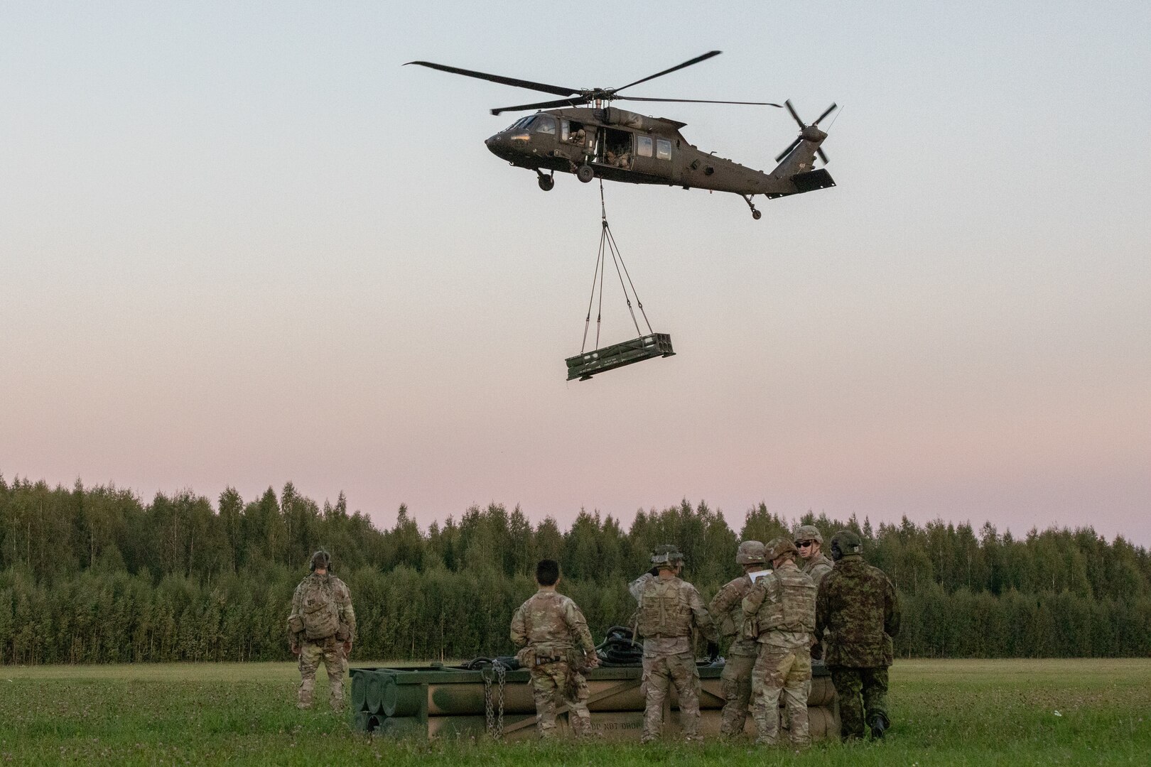 U.S. Army Soldiers assigned to 1st Battalion, 506th Infantry Regiment "Red Currahee," 1st Infantry Brigade Combat Team, 101st Airborne Division (Air Assault); Soldiers with Task Force Knighthawk, 3rd Combat Aviation Brigade, both supporting 4th Infantry Division, conduct sling-load training in Voru, Estonia, Sept. 6. The training exercise demonstrated the capability to rapidly deploy High-Mobility Artillery Rocket System ammunition anywhere across the Baltics. The 4th Inf. Div.'s mission in Europe is to engage in multinational training and exercises across the continent, working alongside NATO allies and regional security partners to provide combat-credible forces to V Corps, America’s forward deployed corps in Europe. (U.S. Army photo by Capt. H Howey)