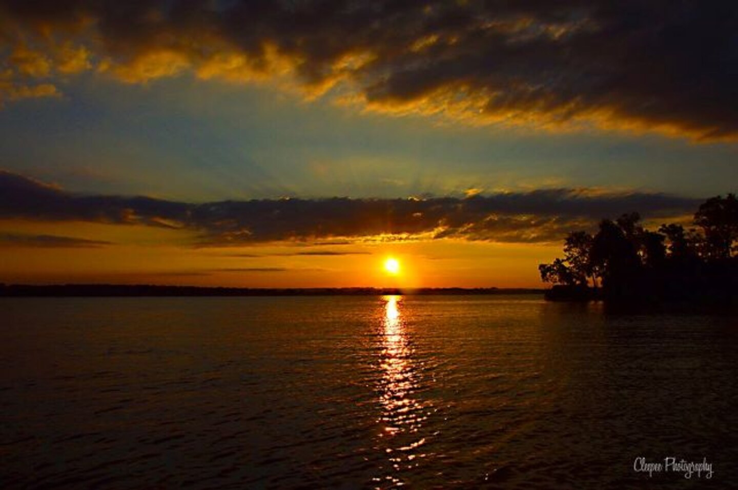 Old Hickory Lake, sunset over a lake with tree line on right