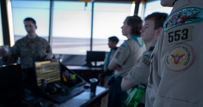 A group of scouts view the flight line from the top floor of the air traffic control tower.