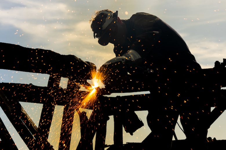 U.S. Marine Corps Cpl. Conlon Kane, a metal worker with Marine Wing Support Squadron (MWSS) 373, Marine Aircraft Group 38, 3rd Marine Aircraft Wing, cuts metal remains of the Bailey Bridge with an air carbon arc cutting system during a bridge demolition operation as part of phase I of Strategic Mobility Exercise (STRATMOBEX) II at San Clemente Island, California, Jan. 6, 2024. During phase I, MWSS-373 demolished a hazardous bridge that hindered range control’s ability to insert targets into the Shore Bombardment Area of San Clemente Island. Phase I set conditions for phases II and III of STRATMOBEX II, the construct of a shallow water crossing and follow on missions. (U.S. Marine Corps photo by Lance Cpl. Jennifer Sanchez)