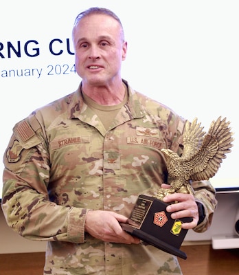 Maj. Gen. Rodney Boyd, the Assistant Adjutant General - Army for the Illinois National Guard and the Commander of the Illinois Army National Guard, presents Air Force Col. Shawn Strahle, the Deputy Commander of the Illinois Air National Guard's 183rd Wing, with the Illinois Army National Guard Staff Eagle.