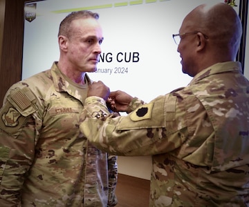 Maj. Gen. Rodney Boyd, the Assistant Adjutant General - Army for the Illinois National Guard and the Commander of the Illinois Army National Guard, presents Air Force Col. Shawn Strahle, the Deputy Commander of the Illinois Air National Guard's 183rd Wing, with the Meritorious Service Medal for more than four years of service as the Director of Information Management, part of the Illinois Army National Guard's staff.