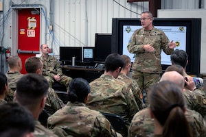 A group of military members in a room.