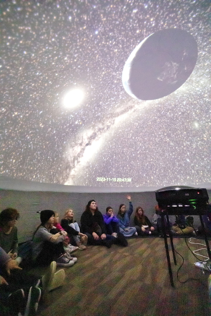 Local fourth- and fifth-grade students from Silver Ridge Elementary School sit inside and watch the stars and planets in a portable planetarium, during STEM Days activities Nov. 15, 2023, at the Puget Sound Navy Museum, in Bremerton Washington. (U.S Navy Photo by Wendy Hallmark)
