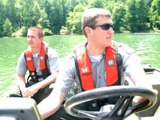 Park Rangers Spencer Taylor (Front) and John Malone, U.S. Army Corps of Engineers Nashville District, take a boat out on Martins Fork Lake in Smith, Ky., May 25, 2011.  Both rangers are participating in a one-year training program that will prepare them for permanent assignments as park rangers in the Nashville District. Two men in a boat.