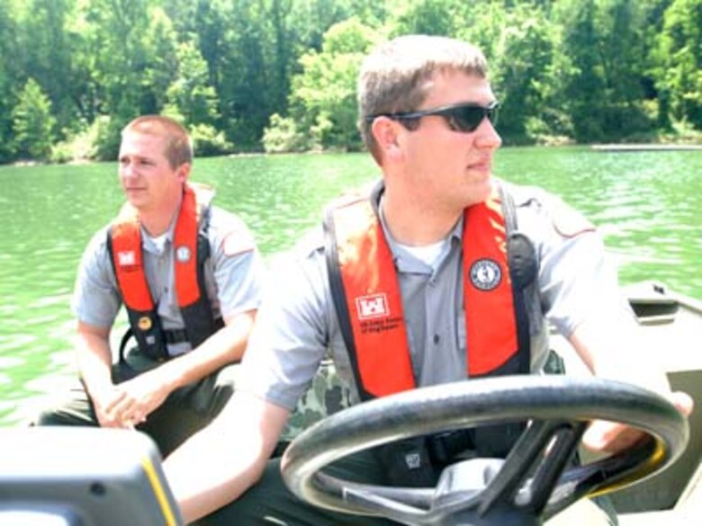 Park Rangers Spencer Taylor (Front) and John Malone, U.S. Army Corps of Engineers Nashville District, take a boat out on Martins Fork Lake in Smith, Ky., May 25, 2011.  Both rangers are participating in a one-year training program that will prepare them for permanent assignments as park rangers in the Nashville District. Two men in a boat.