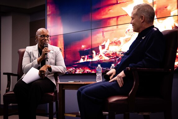 From left, Dr. Cassandra C. Lewis, Chancellor at the National Defense University, talks to Air Force Lt. Gen. Timothy D. Haugh, Deputy Commander of USCYBERCOM, during the Fire Side Chat of the Cyber Symposium at the National Defense University in Washington, D.C. on December 5, 2023.