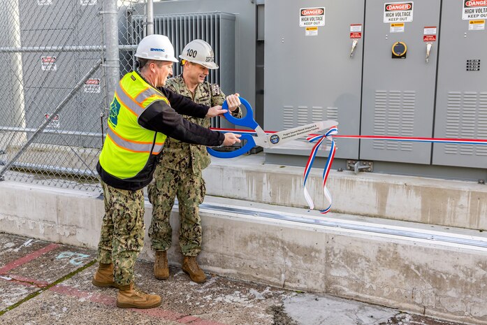 Capt. JD Crinklaw, commander, Puget Sound Naval Shipyard &
Intermediate Maintenance Facility, and Capt. Brent Paul, commander, Naval Facilities Engineering Systems Command, Northwest, cut the ribbon for a new substation near Dry dock 4 at the shipyard in Bremerton, Washington, Nov. 20, 2023. (U.S. Navy photo by Jeb Fach)