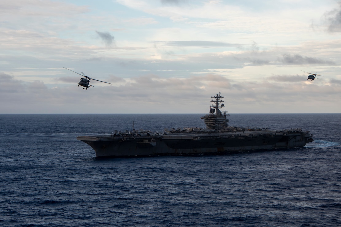 PACIFIC OCEAN (May 31, 2023) Two MH-60R Sea Hawk helicopters from the “Battlecats” of Helicopter Maritime Strike Squadron (HSM) 73 fly near the aircraft carrier USS Nimitz (CVN 68). Nimitz is in U.S. 7th Fleet conducting routine operations. 7th Fleet is the U.S. Navy's largest forward-deployed numbered fleet, and routinely interacts and operates with allies and partners in preserving a free and open Indo-Pacific region. (U.S. Navy photo by Mass Communication Specialist 2nd Class Samuel Osborn)