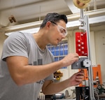 Stanley Kitowski, industrial engineer, Code 100PI, Lean Office, at Puget Sound Naval Shipyard & Intermediate Maintenance Facility, has designed an automated process for bending copper wire staples, at the command in Bremerton, Washington. (U.S Navy photo by Wendy Hallmark)