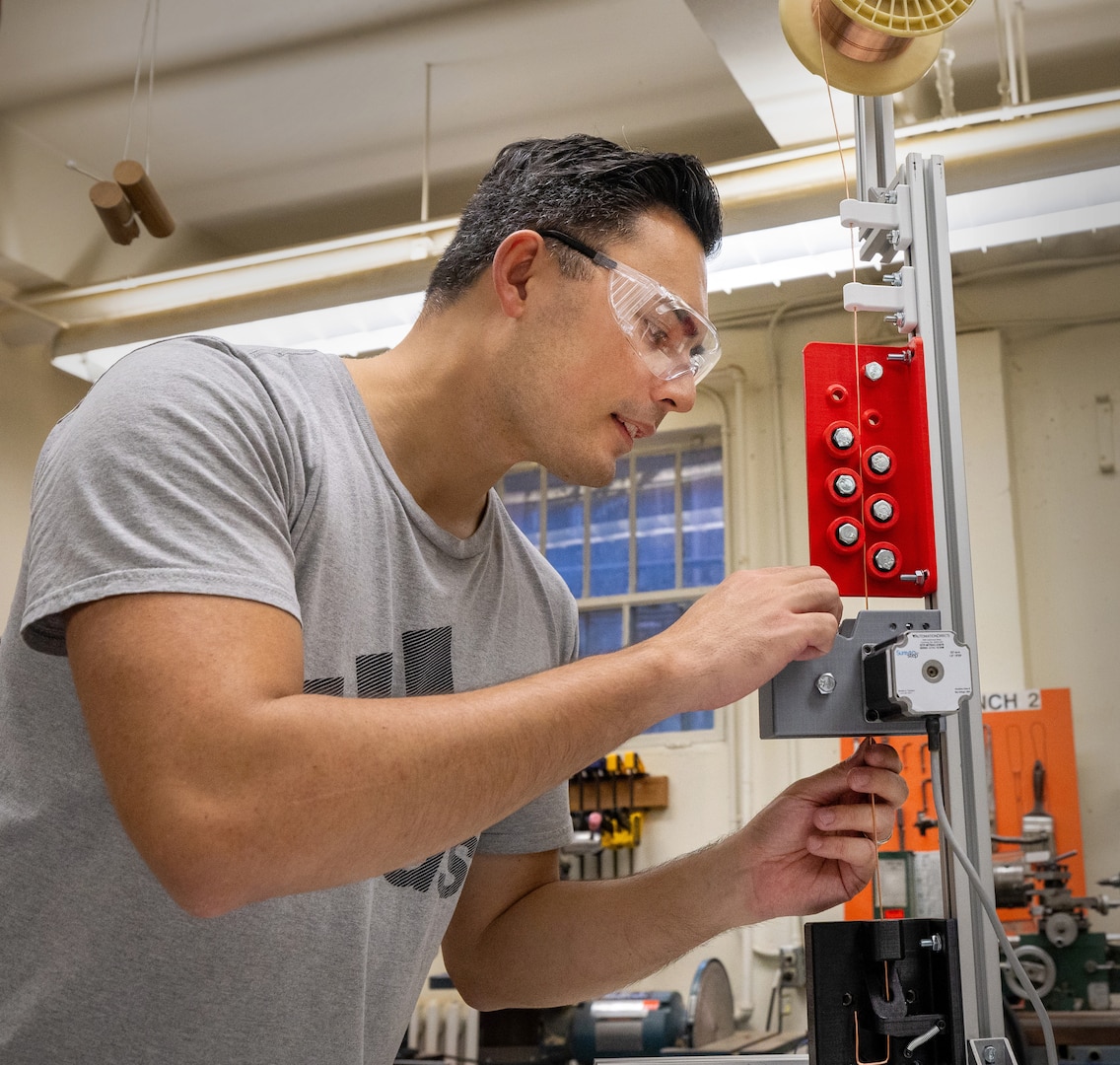 Stanley Kitowski, industrial engineer, Code 100PI, Lean Office, at Puget Sound Naval Shipyard & Intermediate Maintenance Facility, has designed an automated process for bending copper wire staples, at the command in Bremerton, Washington. (U.S Navy photo by Wendy Hallmark)