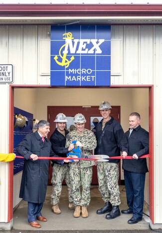 From left, Robert Bianchi, chief executive officer, Navy Exchange Service Command; Master Chief Michael C. Gosart, command senior enlisted leader, Puget Sound Naval Shipyard &
Intermediate Maintenance Facility; Capt. JD Crinklaw, commander, PSNS & IMF; Rear Adm. Scott M. Brown, deputy commander, Industrial Operations, Naval Sea Systems Command; and James Cook, deputy executive director, PSNS & IMF, cut the ribbon to officially open the new NEXCOM Micro Market inside Building 1246, at the command in Bremerton, Washington, Dec. 7, 2023. (U.S Navy Photo by Wendy Hallmark)