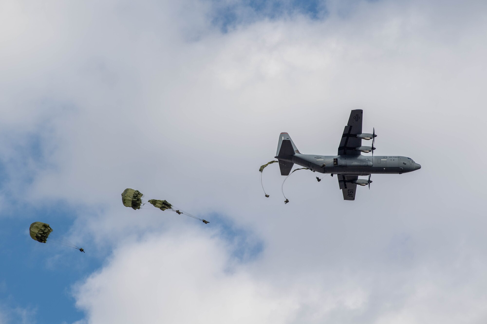 Japan Ground Self-Defense Force paratroopers from the 1st Airborne Brigade jump out of a U.S. Air Force C-130J Super Hercules assigned to the 36th Airlift Squadron during the annual New Year's Jump exhibition at Camp Narashino, Japan.