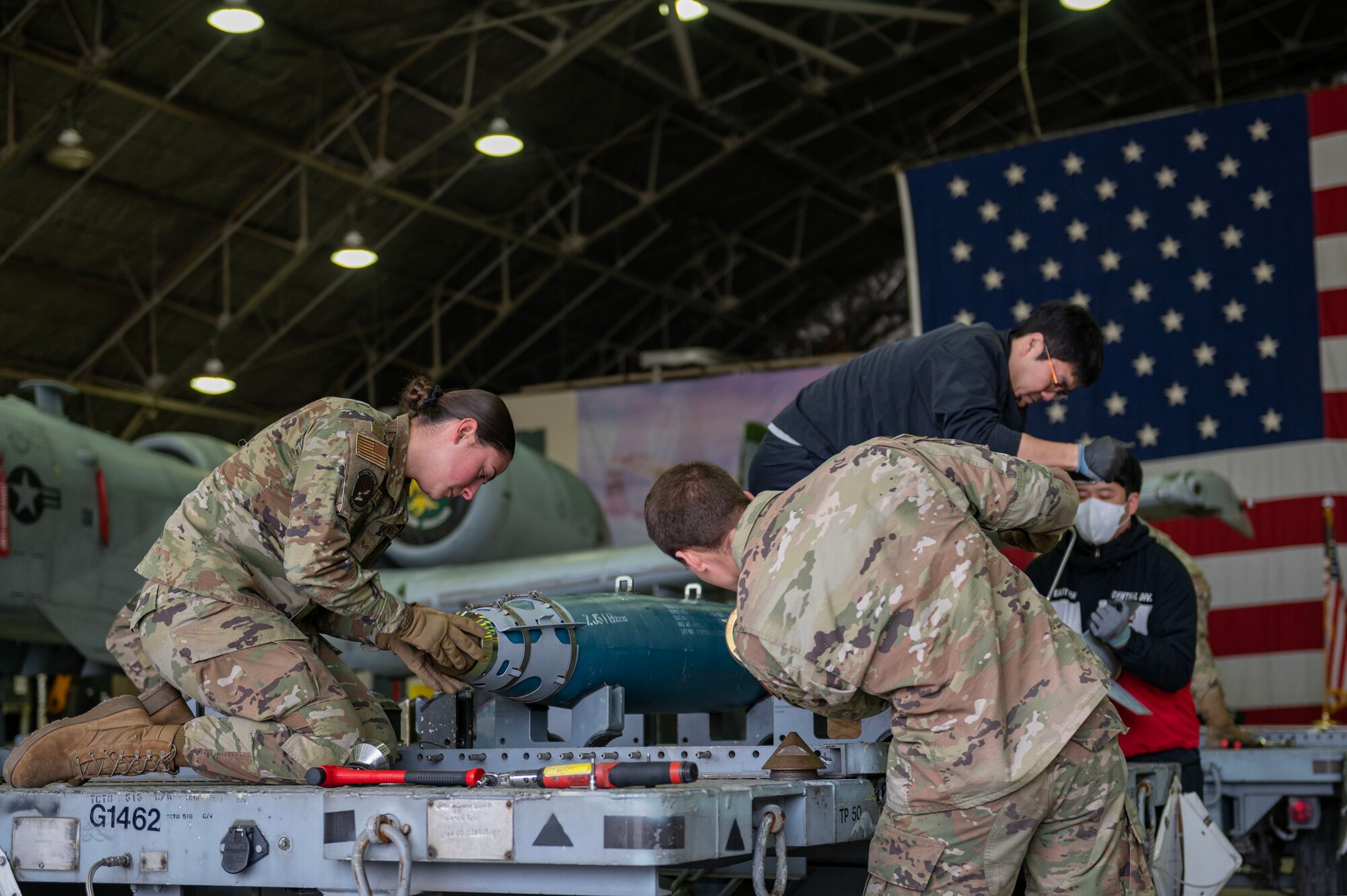 Members from the 51st Munitions Squadron prepare munitions to be loaded during a quarterly load crew competition at Osan Air Base, Republic of Korea, Jan. 5, 2024. Before a load crew competition takes place, conventional maintenance technicians participate in a bomb-building competition. The munitions constructed are then loaded onto aircraft during the load crew competition, completing the real-world process from start to finish, creating comprehensive training, and enhancing interoperability between both career fields. (U.S. Air Force photo by Staff Sgt. Aubree Owens)