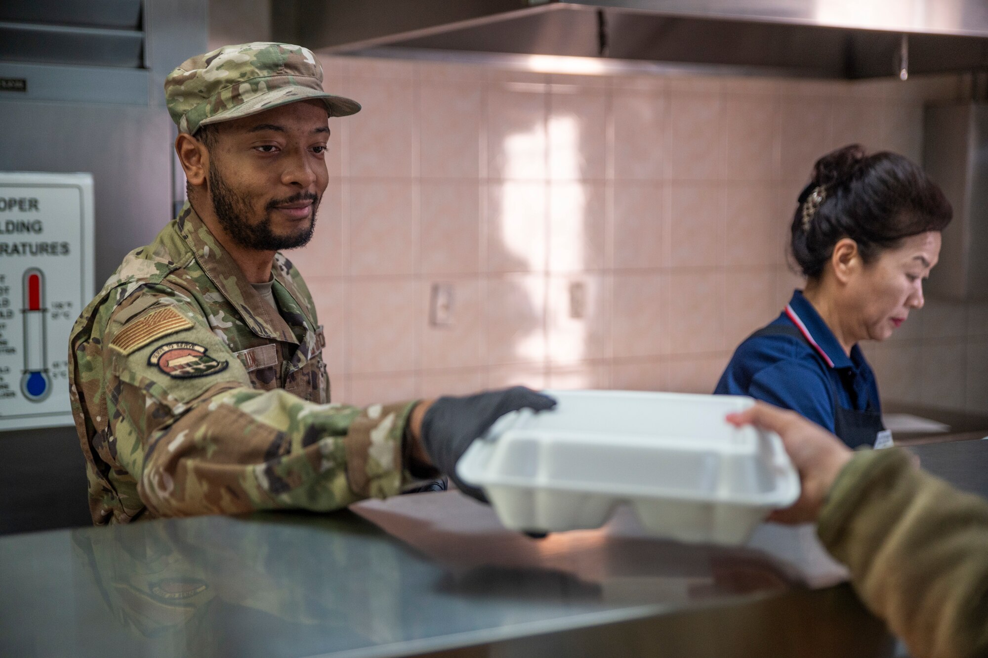 U.S. Air Force Senior Airman Trevor Allen, 51st Force Support Squadron food services journeyman, serves food at the flight line dining facility on Osan Air Base, Republic of Korea, Jan. 8, 2024. The facility supports the 51st Fighter Wing mission by providing breakfast, lunch, and dinner to more than 300 personnel daily, allowing them to replenish and continue to accomplish critical tasks. (U.S. Air Force photo by Senior Airman Trevor Gordnier)