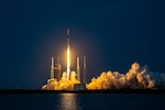 A rocket launches at night.