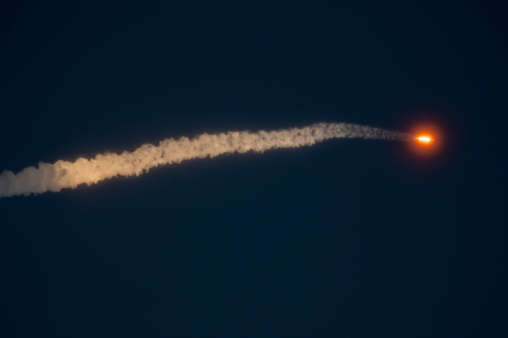 A rocket launches at night.